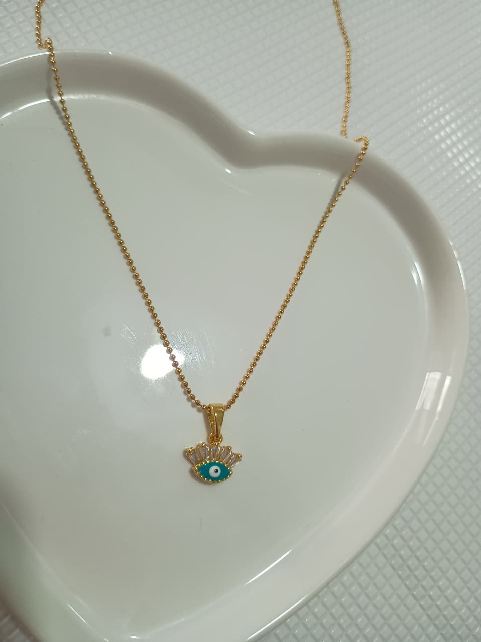 COLAR DELICADO OLHO GREGO - AÇO DOURADO.